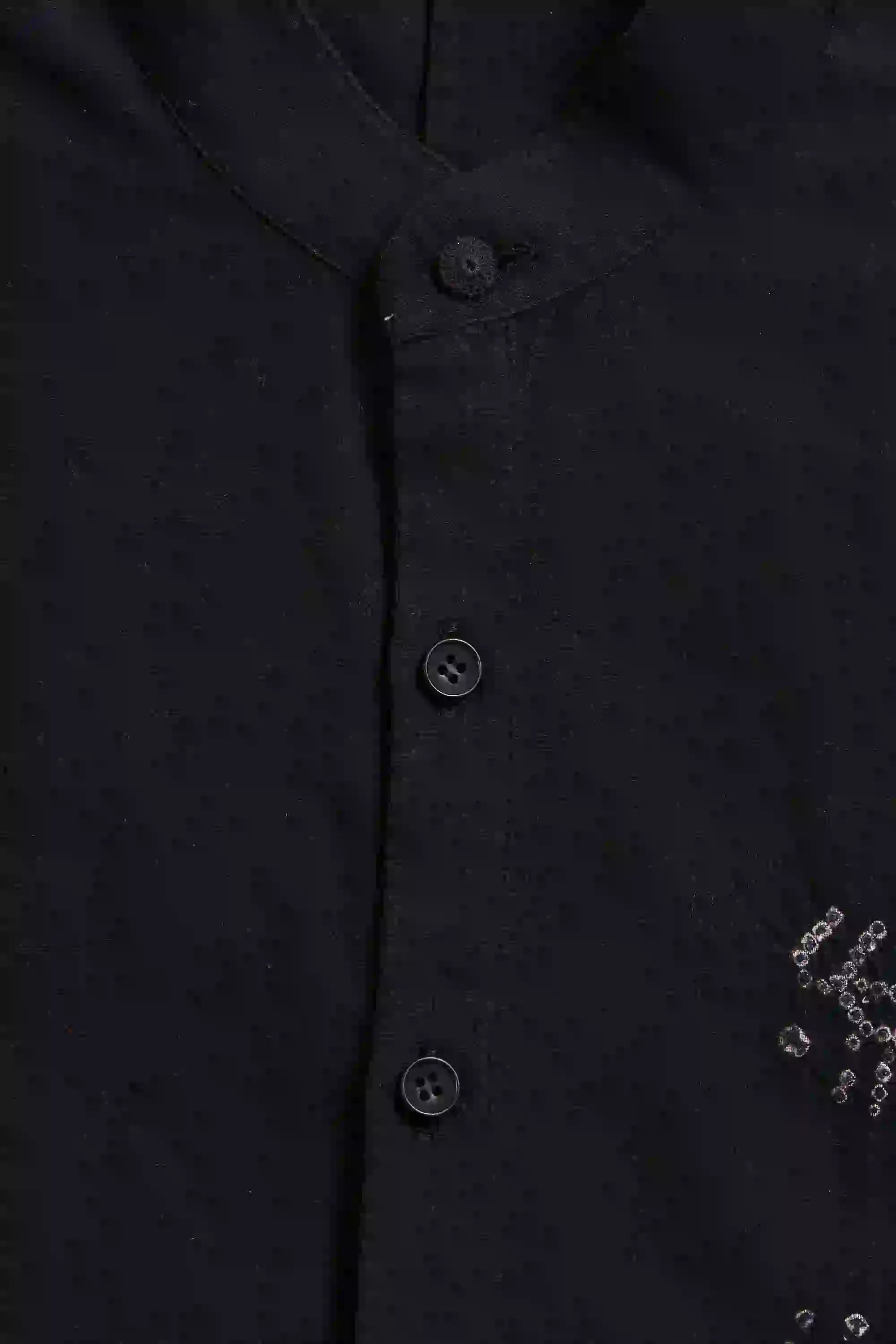 Close-up of a black bandhani shirt with buttons