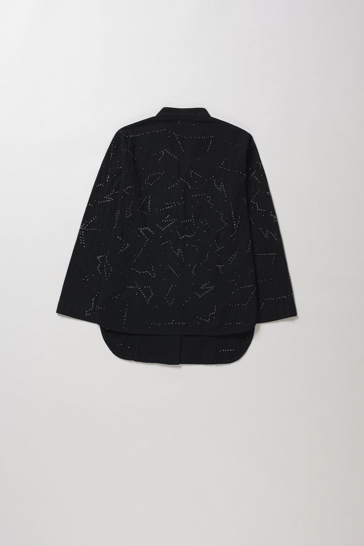 A black long-sleeve cropped shirt with shibori artwork, shown from the back against a light grey background.