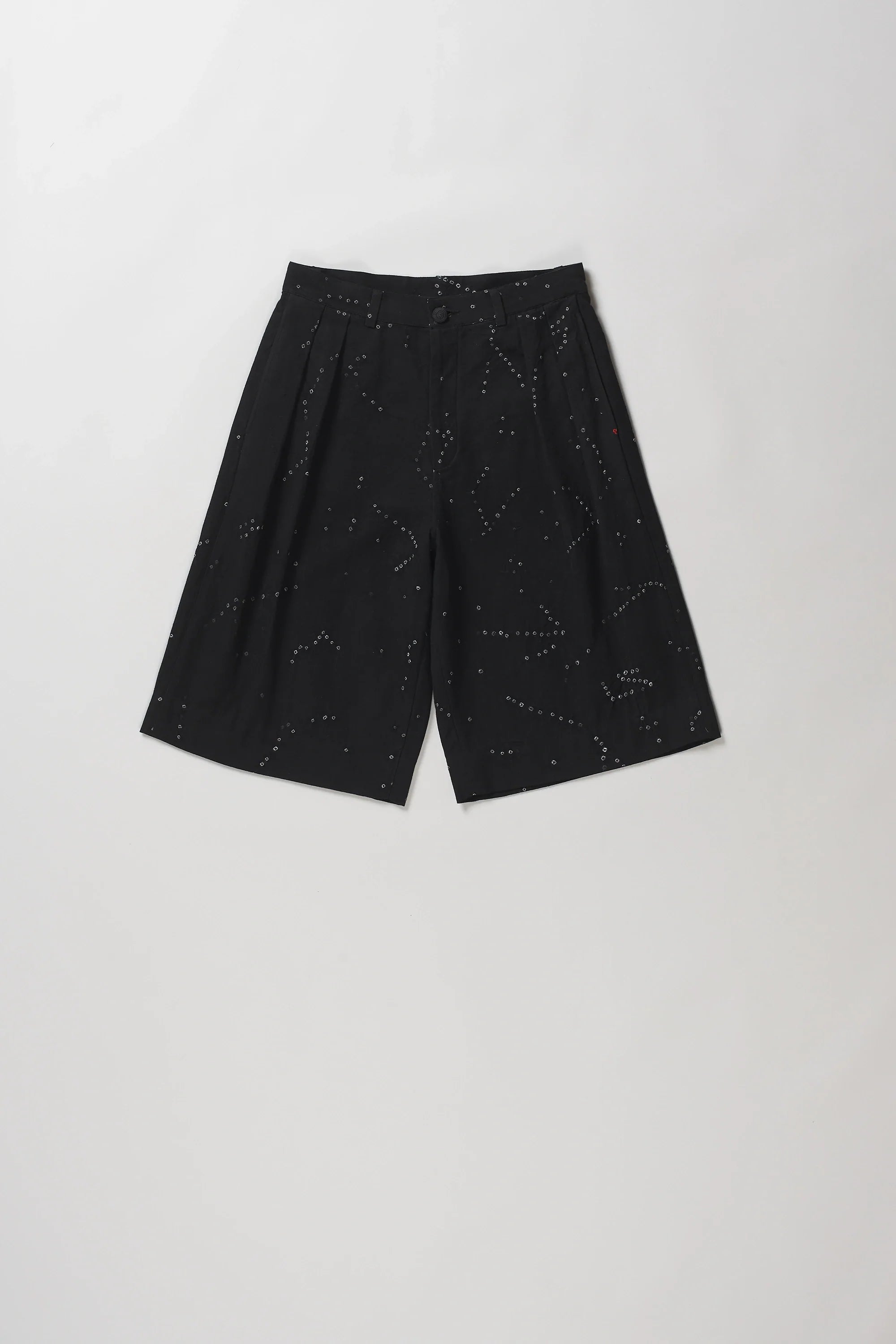 Black wide-leg shorts with a subtle white speckled constellation pattern, laid flat on a light grey background.