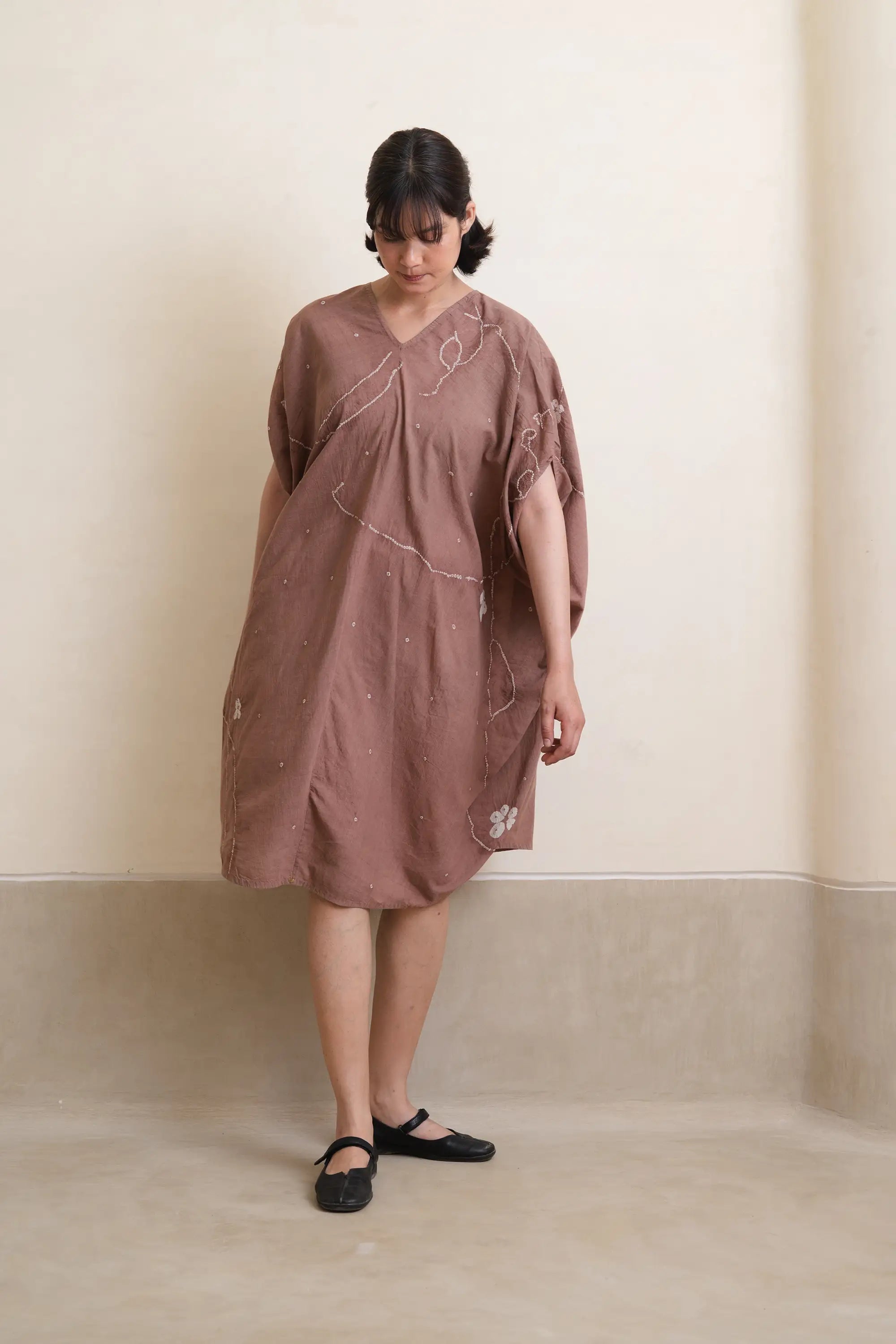 A woman wearing cotton old rose dress