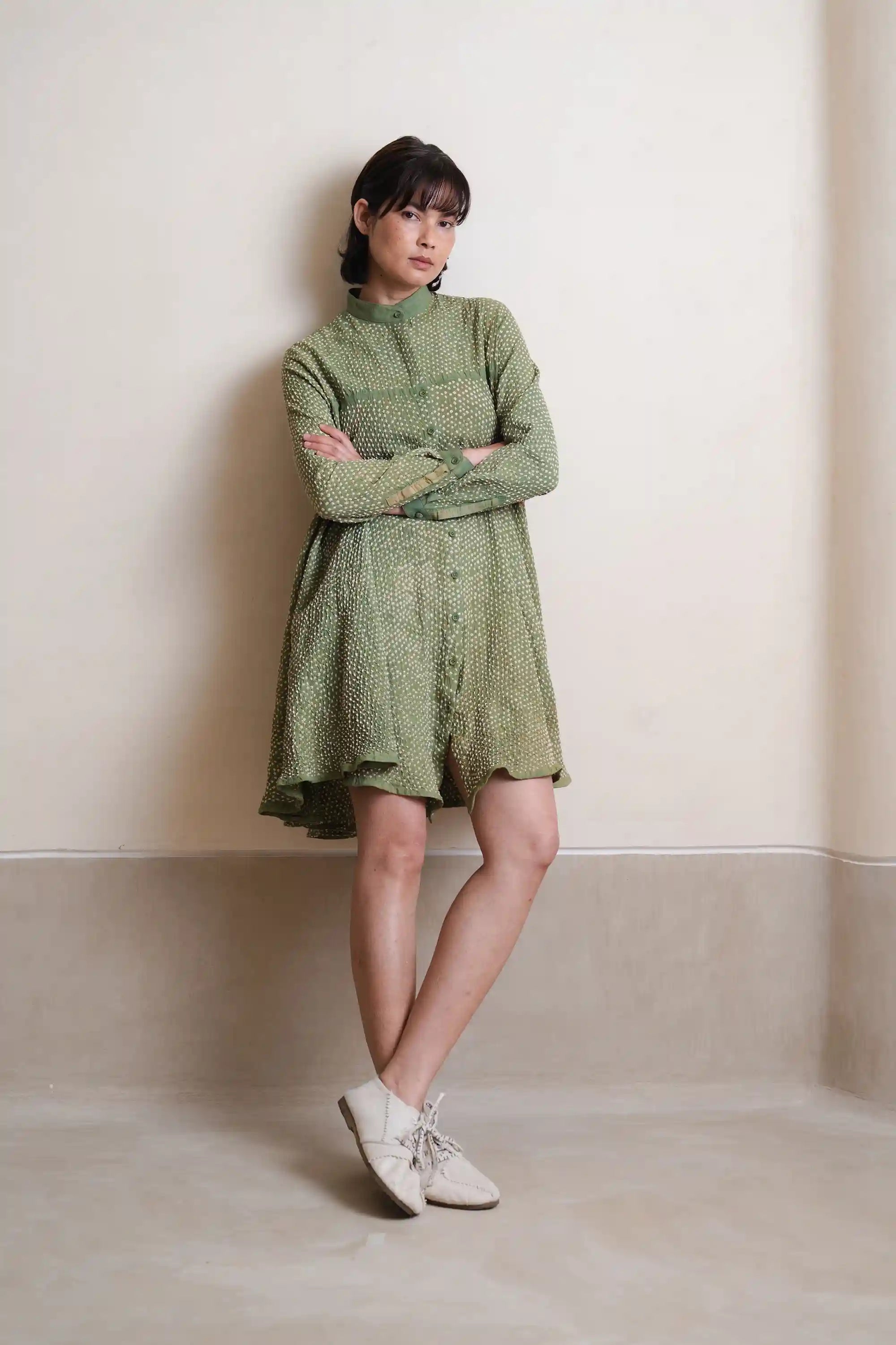 A woman wearing turf green cotton dress