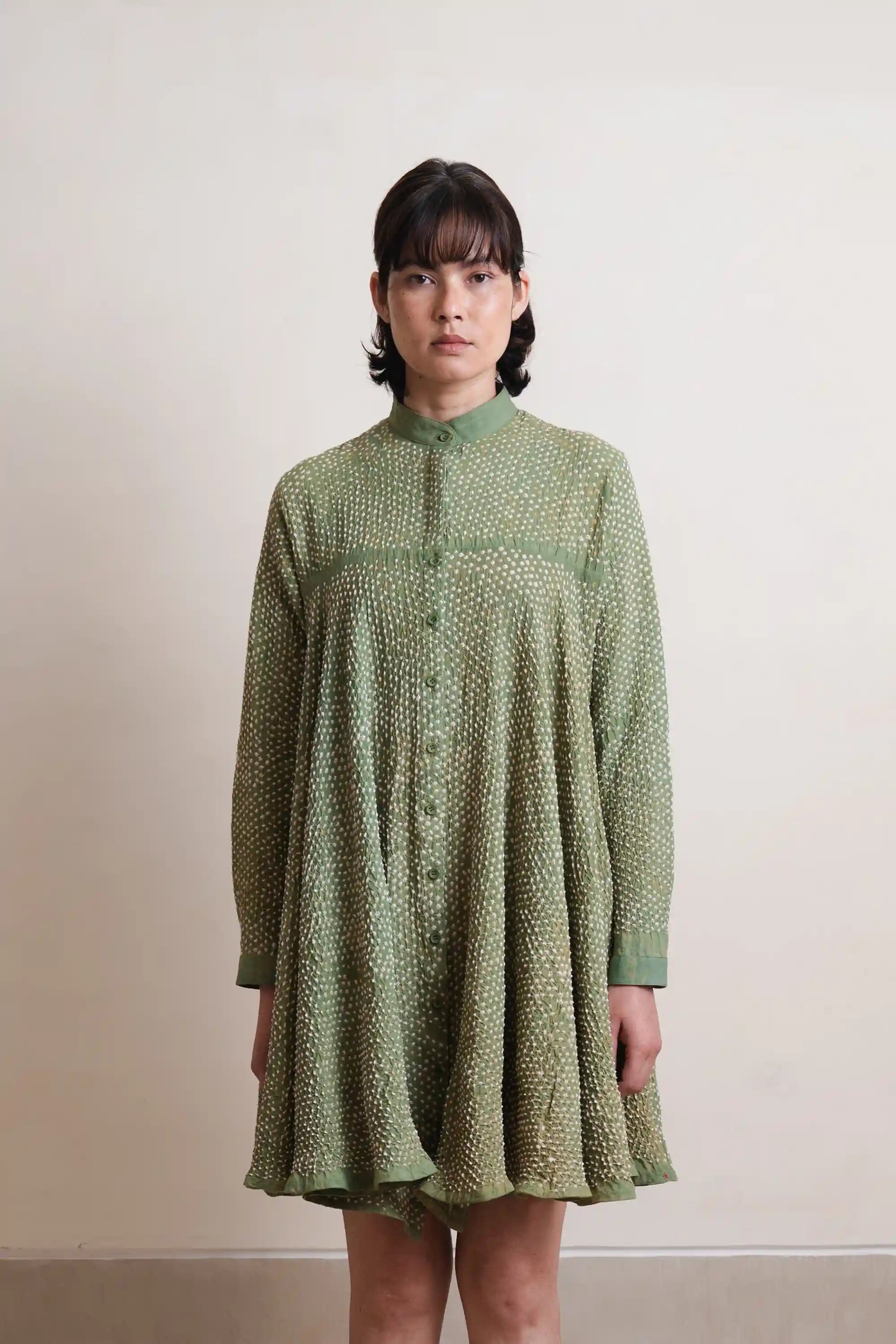 A woman wearing turf green cotton dress