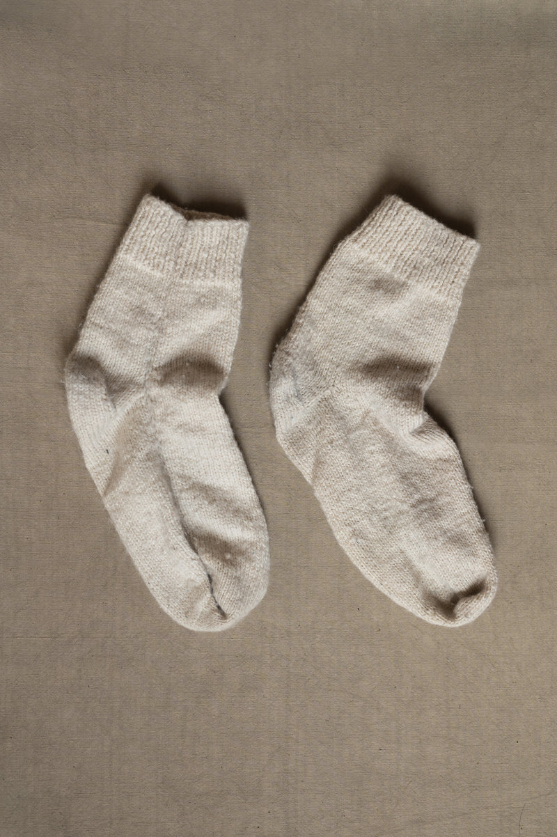 HAND-KNITTED PAIR OF SOCKS IN ECRU