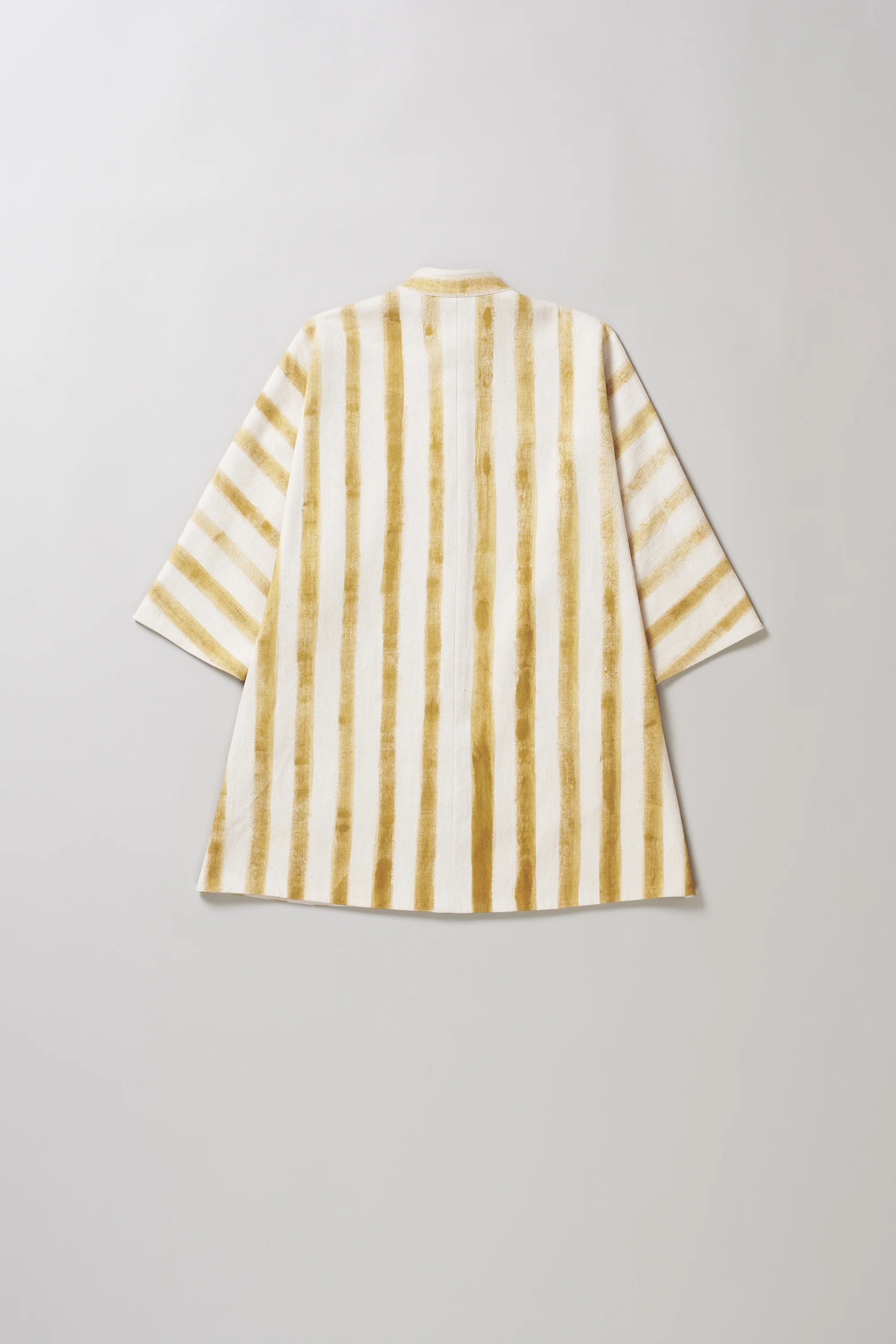 Back image of a striped shirt with yellow and white pattern on a light grey background