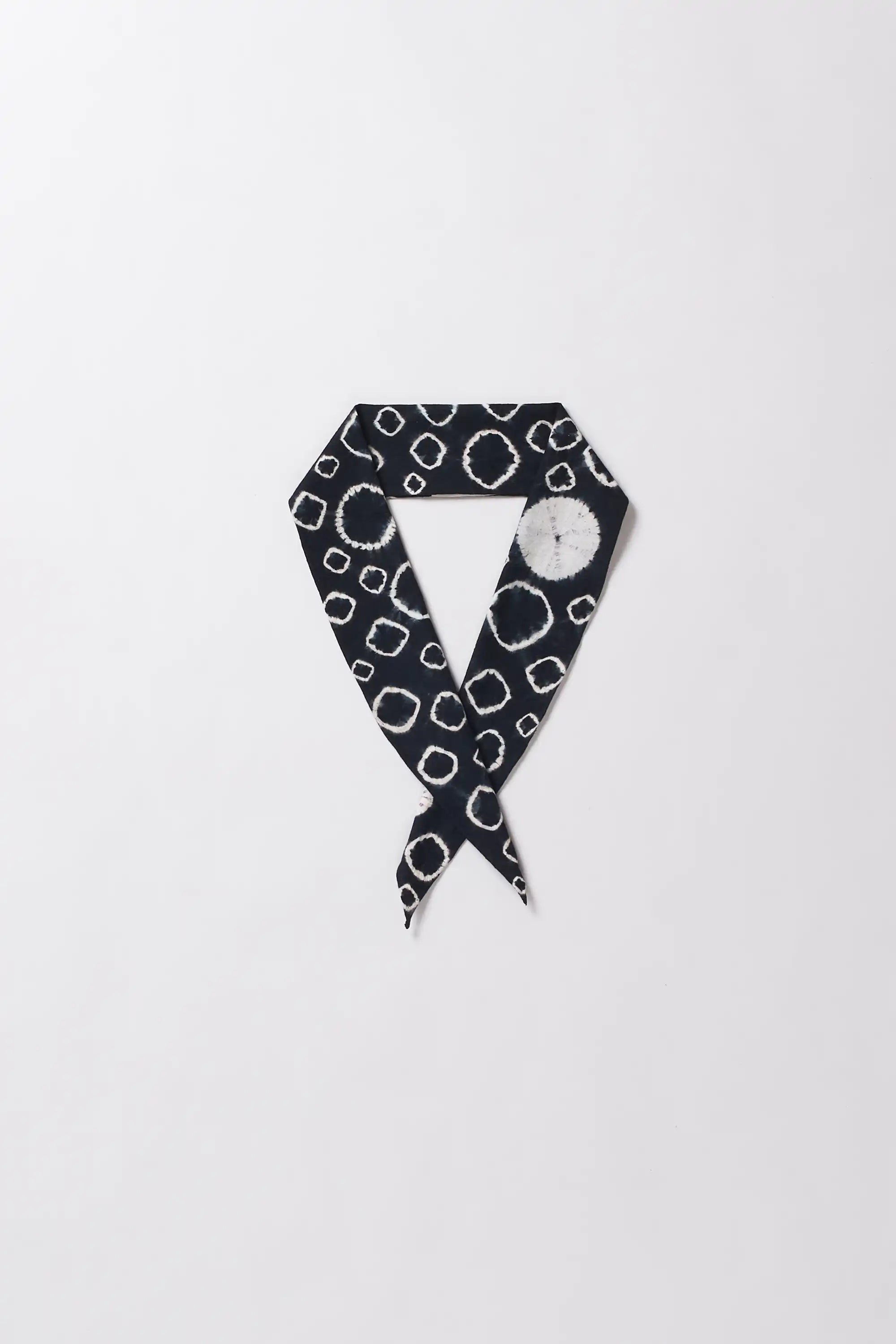 Black and white patterned bandana on a light grey background