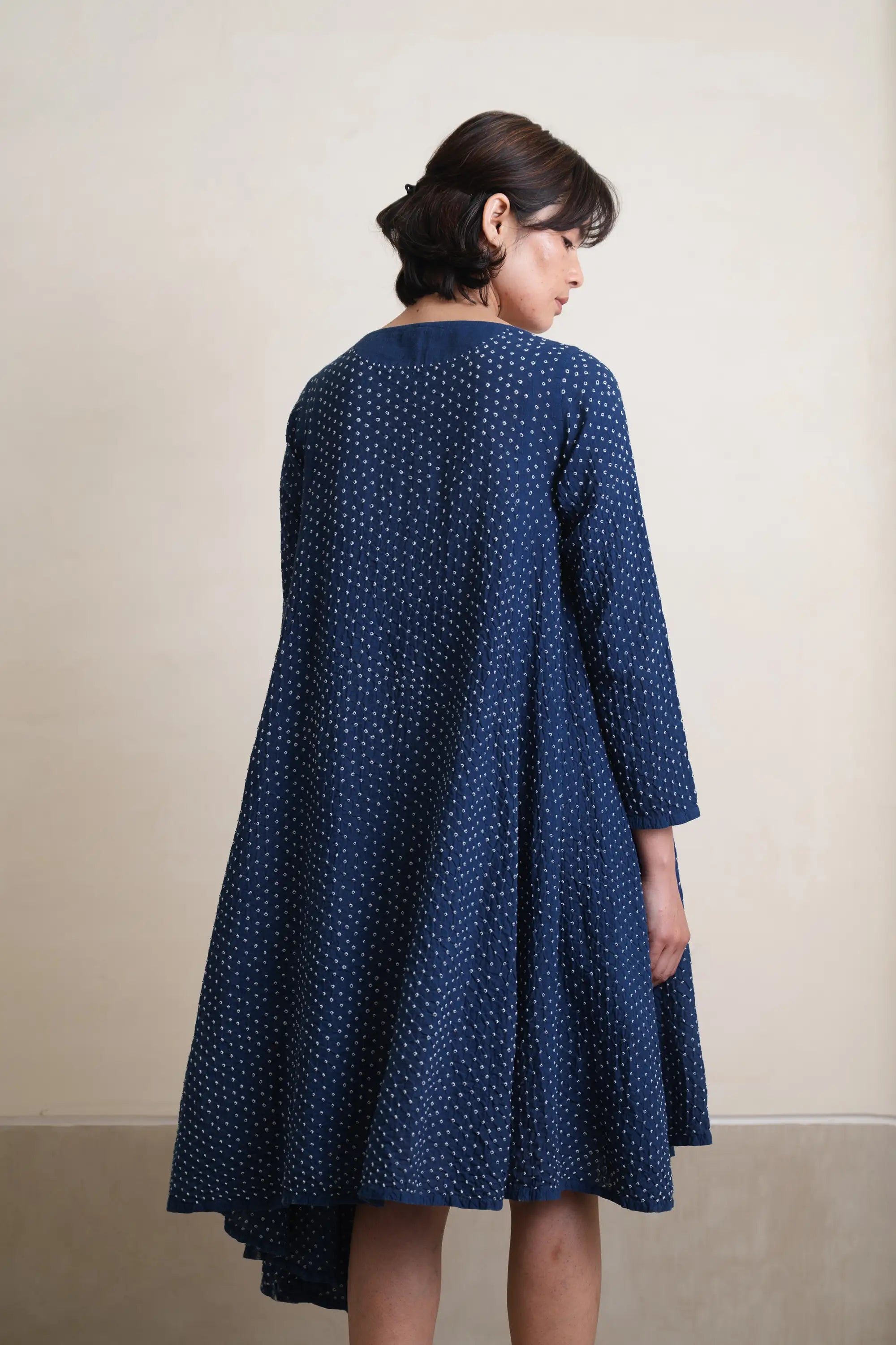 A back shot of woman wearing medium indigo dress