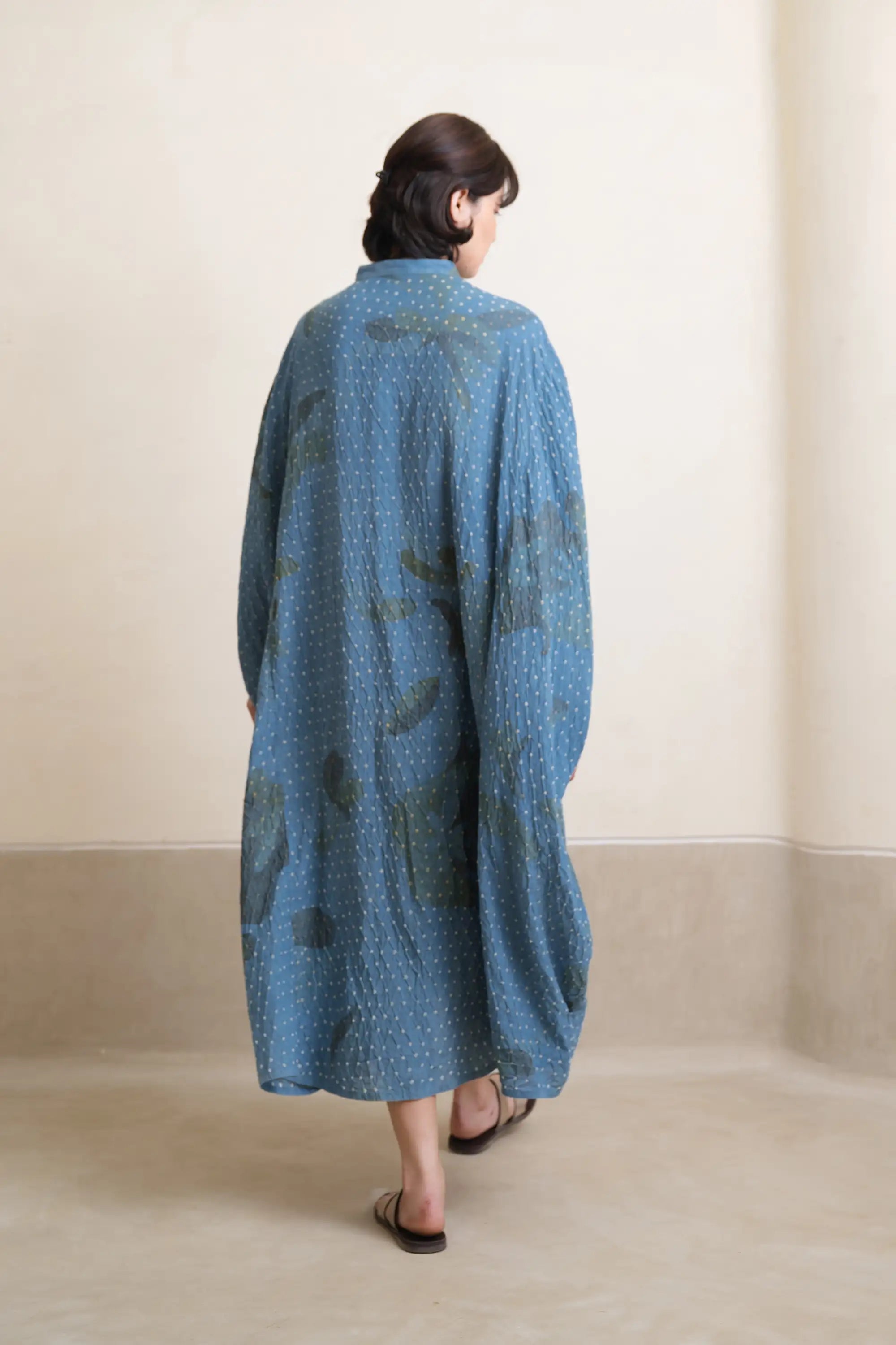 A back shot of woman wearing cotton light indigo dress