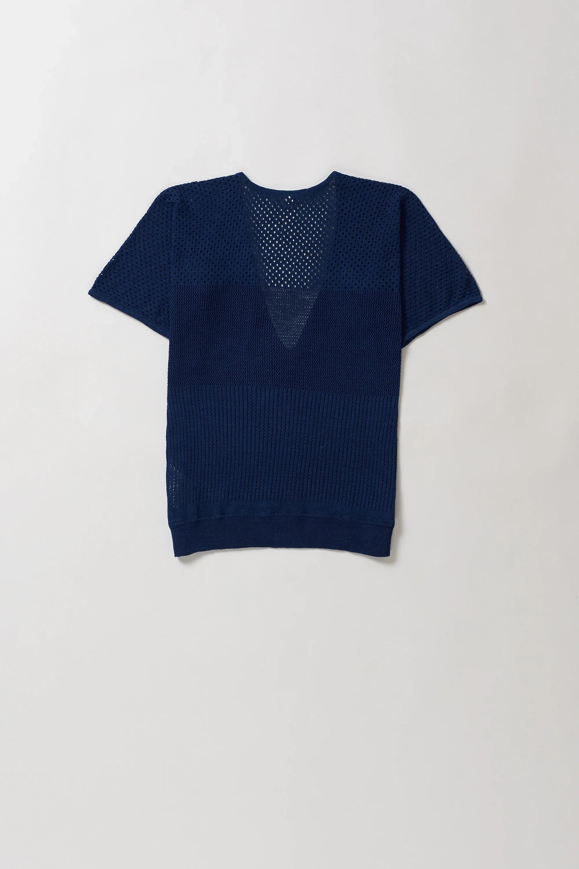 Blue knitted t-shirt on a light grey background