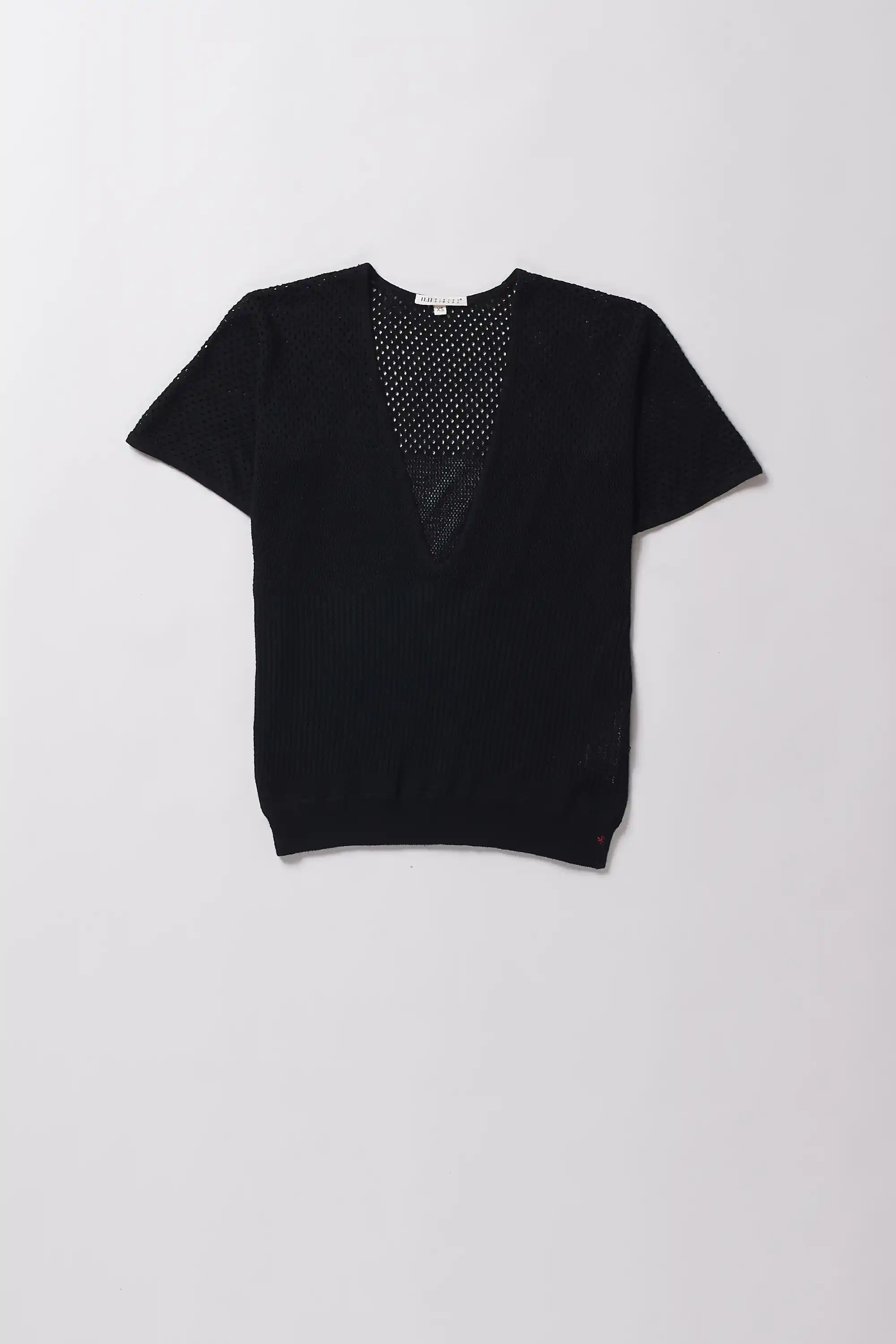 Black V-neck top with mesh detail on a grey background