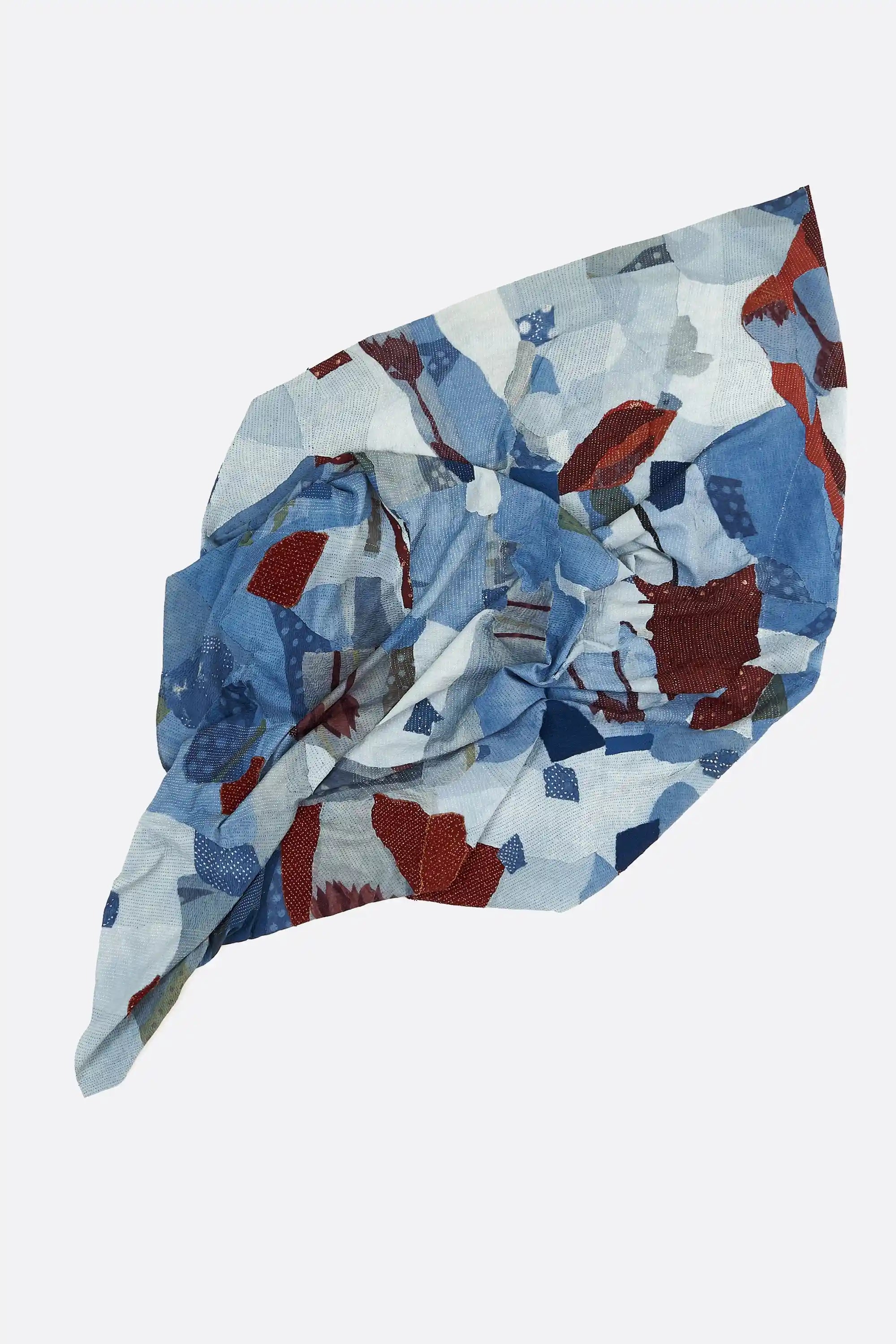 Indigo patchwork kantha quilt on a white background
