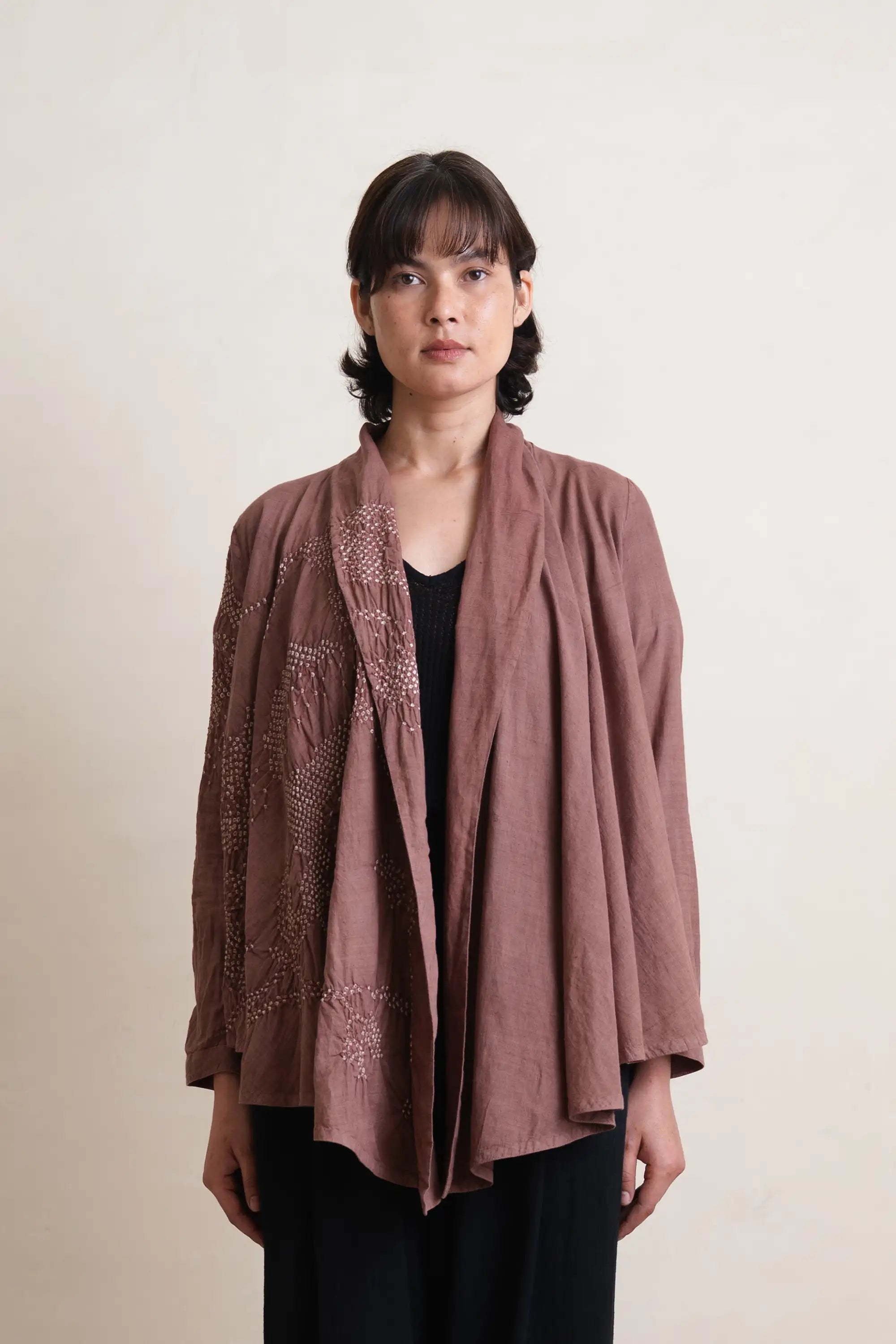 A woman wearing cotton old rose shrug