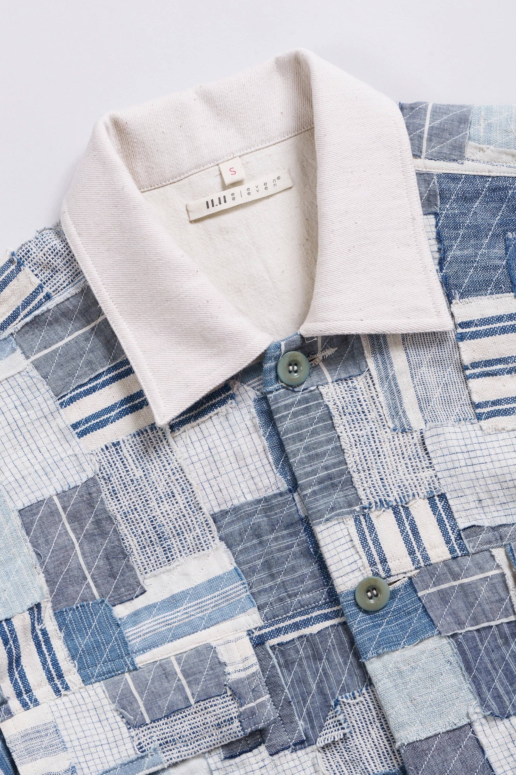Close-up of a fabric with a patterned design and a beige collar.