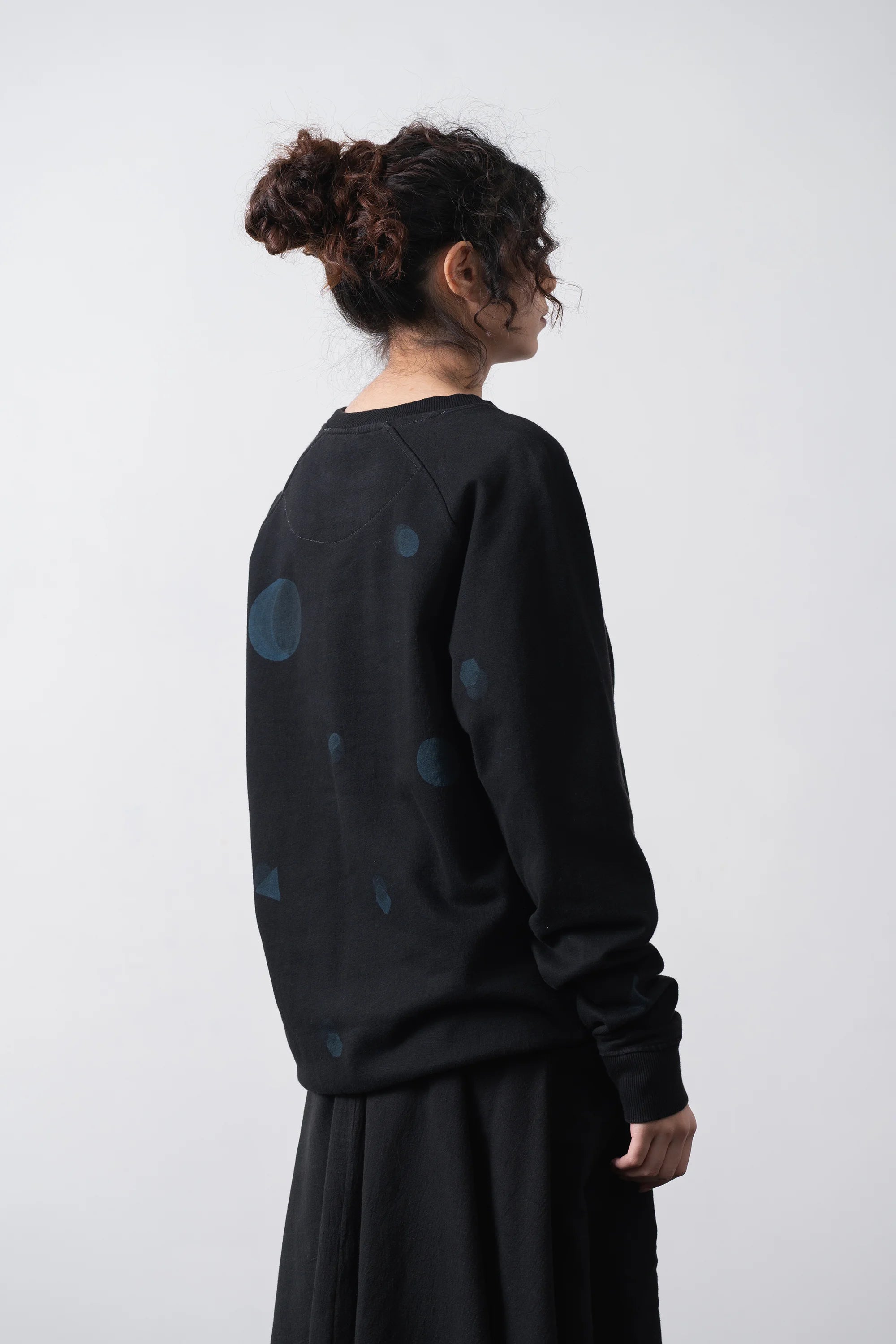 Back shot a woman wearing cotton black sweatshirt