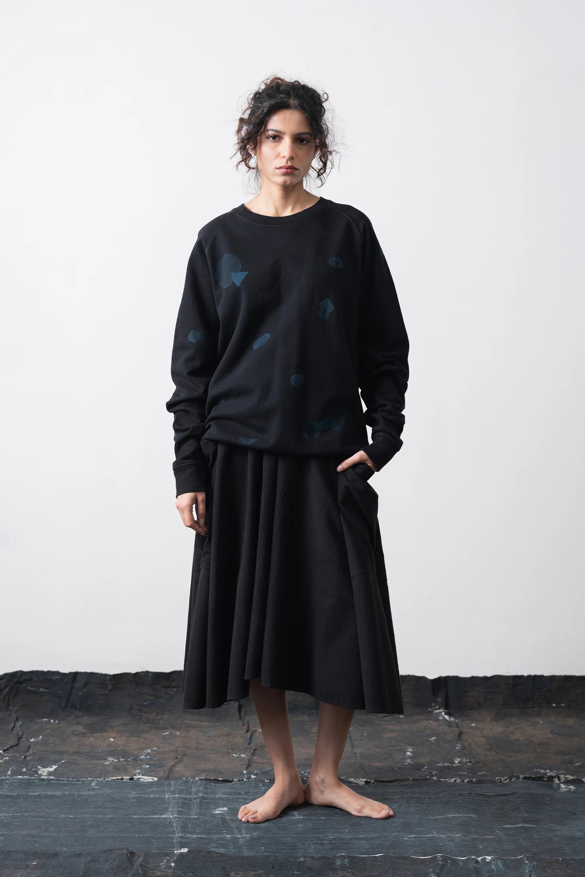A woman wearing cotton black sweatshirt with artwork