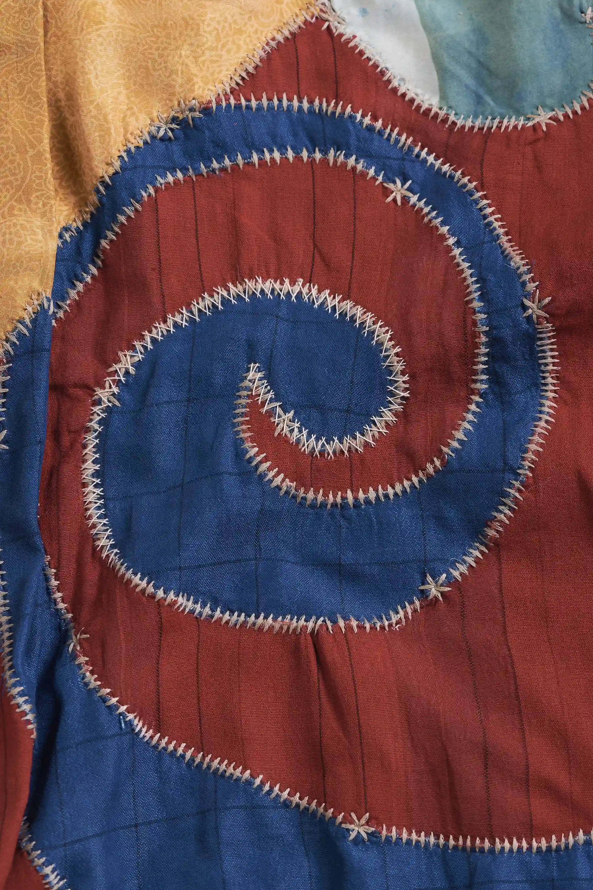 Close-up of a shirt with a spiral pattern on a multicolored background