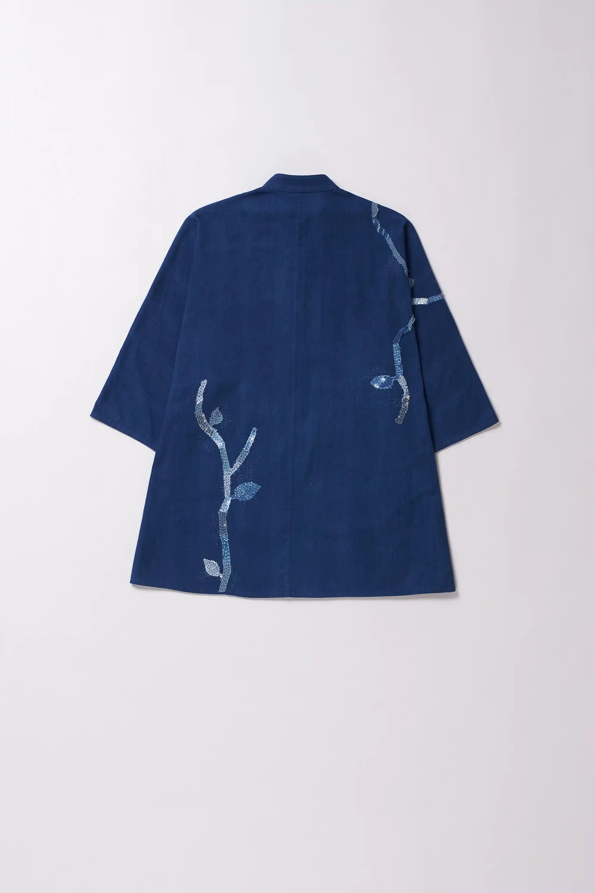 Blue kimono-style garment with white floral patterns on a white background