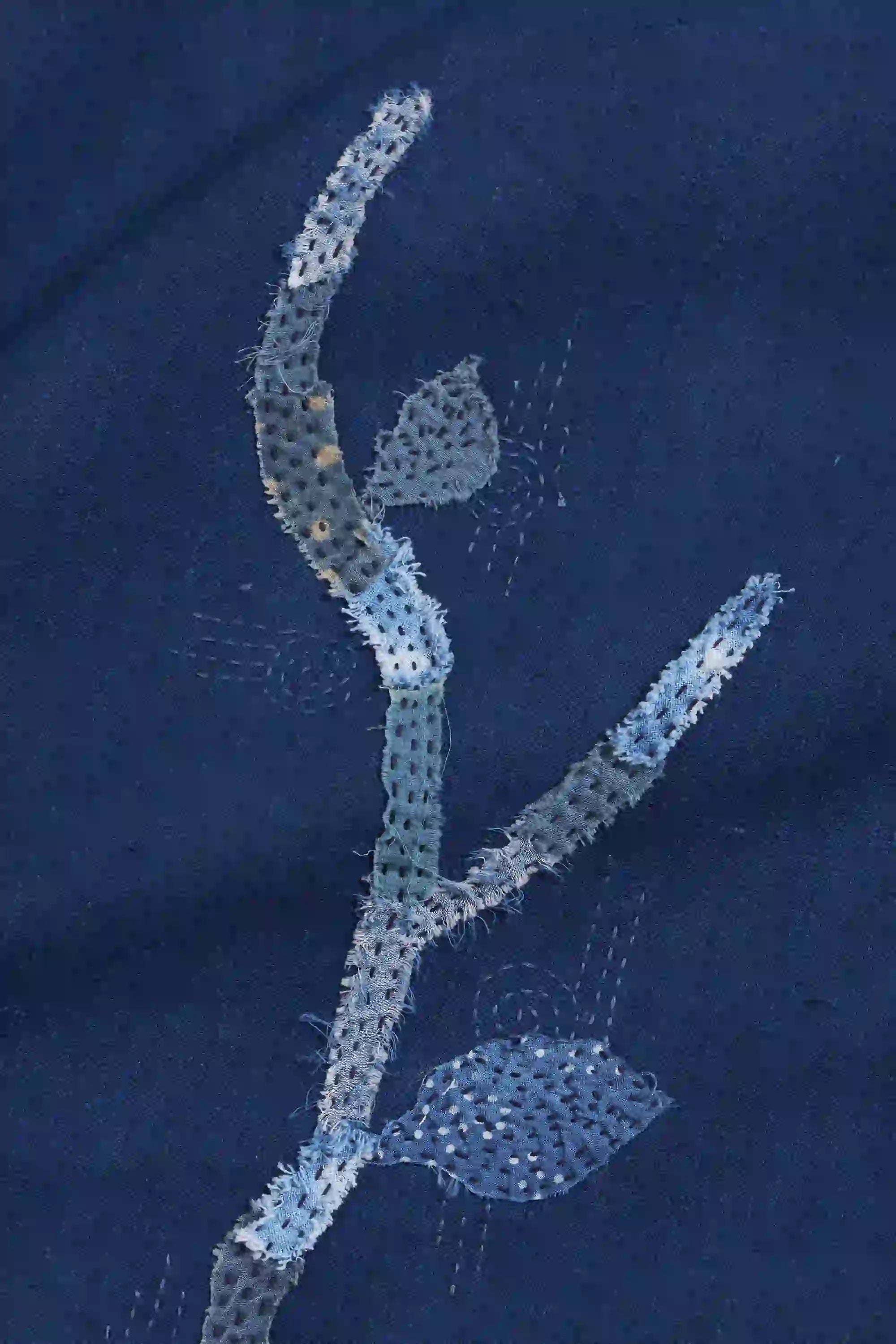 Decorative floral pattern on a dark blue fabric background
