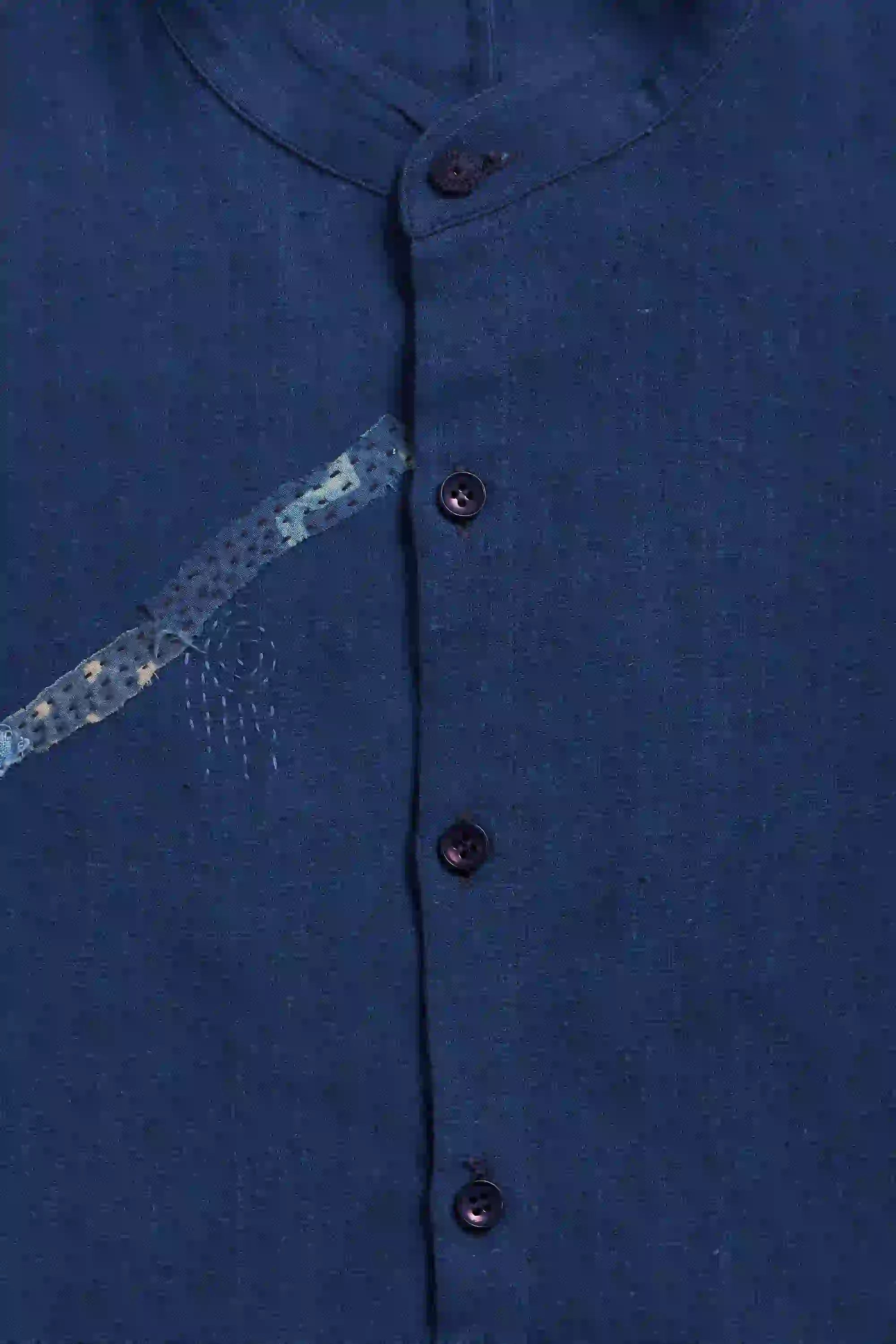 Close-up of a blue shirt with button details