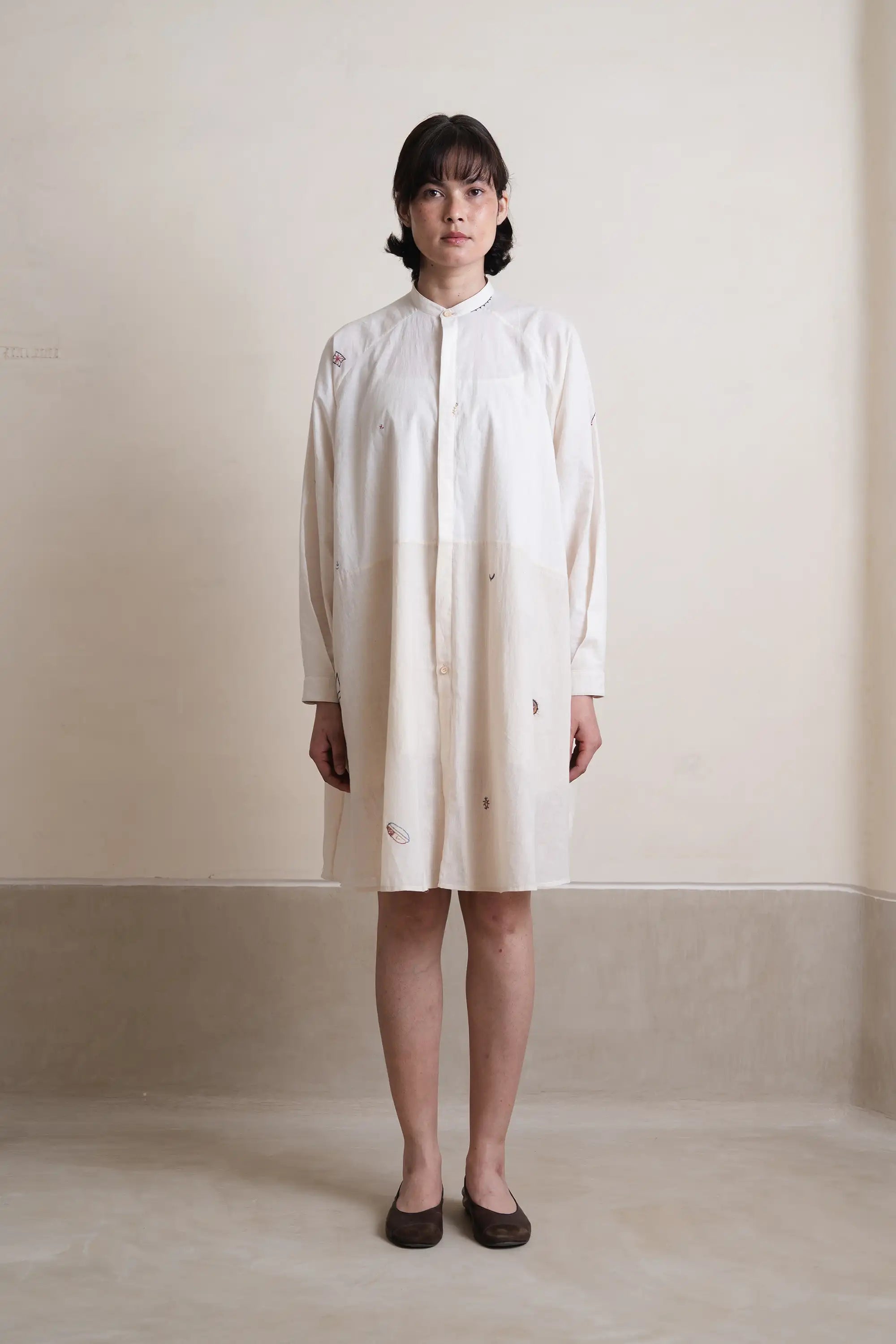 A woman wearing ecru cotton dress