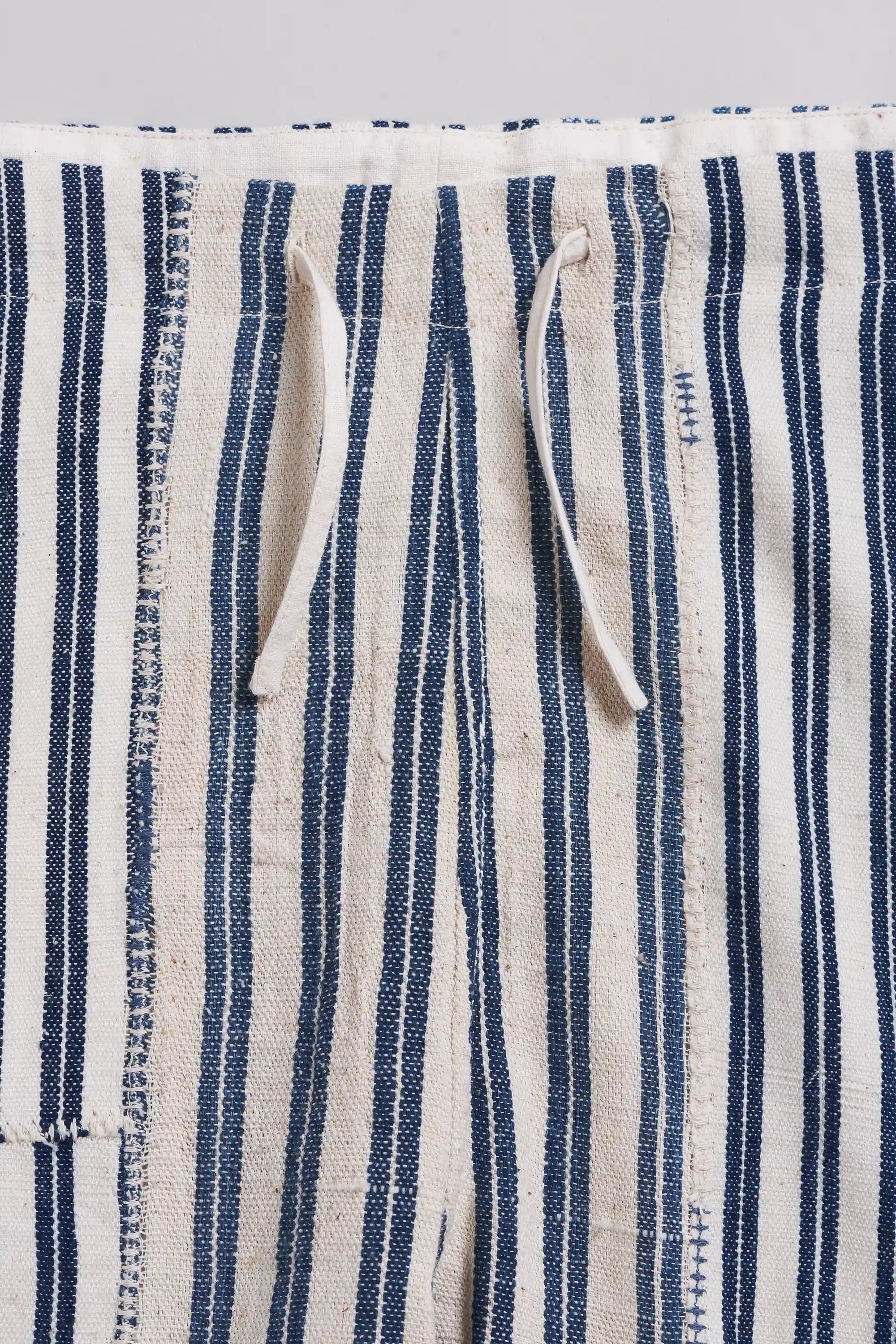 Close-up of striped fabric with drawstring waistband.